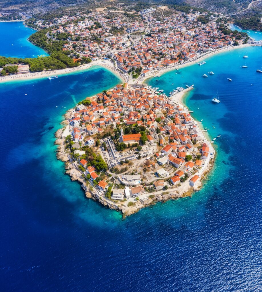 Primosten town, Croatia. View of the city from the air. Seascape with beach and old town.